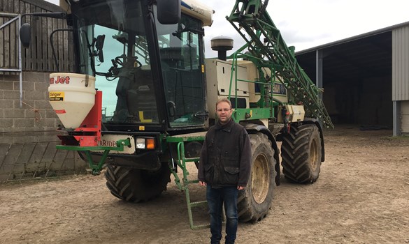 a person standing next to a large tractor
